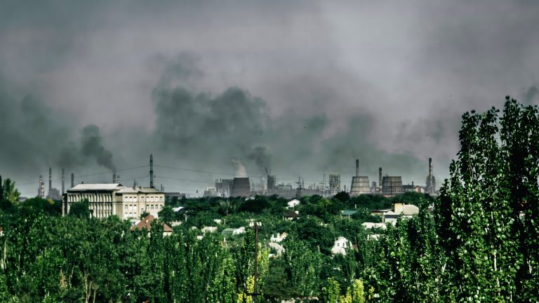 Distance view on smoke smoke rising from the chimneys of metallurgical plant