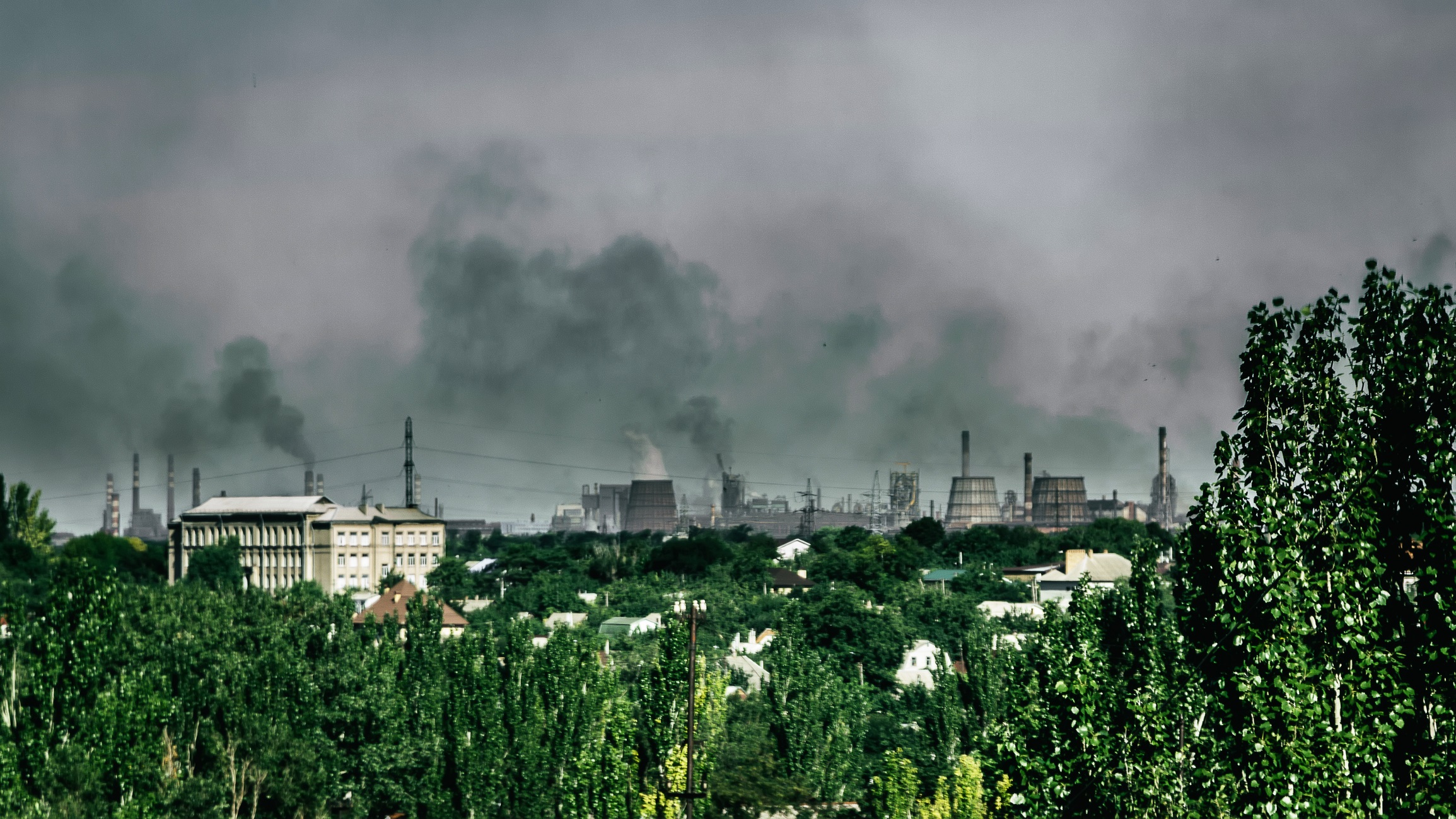 Distance view on smoke smoke rising from the chimneys of metallurgical plant